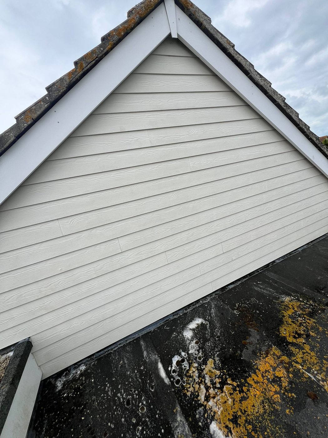 Soffit and fascia cleaning along a roofline in West Sussex