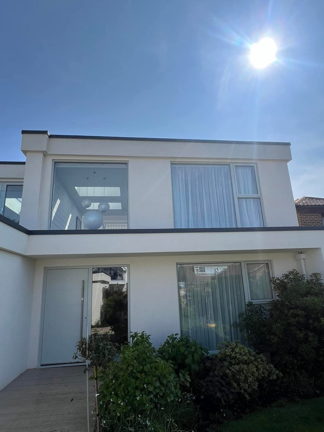 Bright, streak-free windows on a modern coastal West Sussex home after a pure-water clean