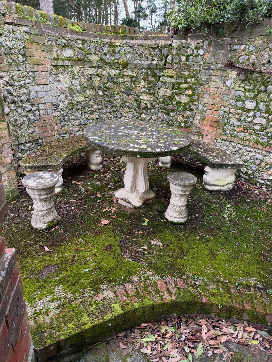 Mossy stone garden table and stools before cleaning